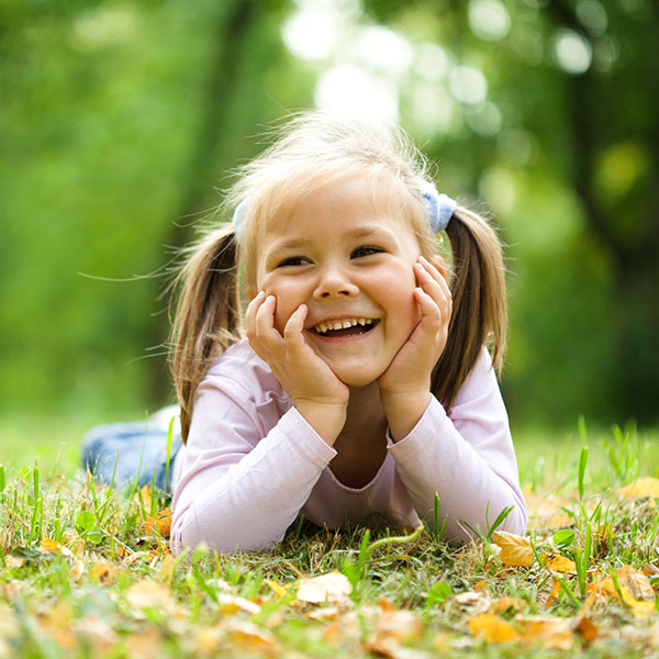 Young Girl in the Grass with Pigtails